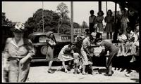 American Women's Hospitals, Rural Services mobile clinic vaccinating a boy (photograph), circa 1935<blockquote class="juicy-quote">An American Women’s Hospital doctor ( in “AWH” armband) tries to administer a shot to a local child in Jellico, Tennessee.</blockquote><div class="view-evidence"><a href="https://doctress.org/islandora/object/islandora:1859/story/islandora:2087" class="btn btn-primary custom-colorbox-load"><span class="glyphicon glyphicon-search"></span> Evidence</a></div>